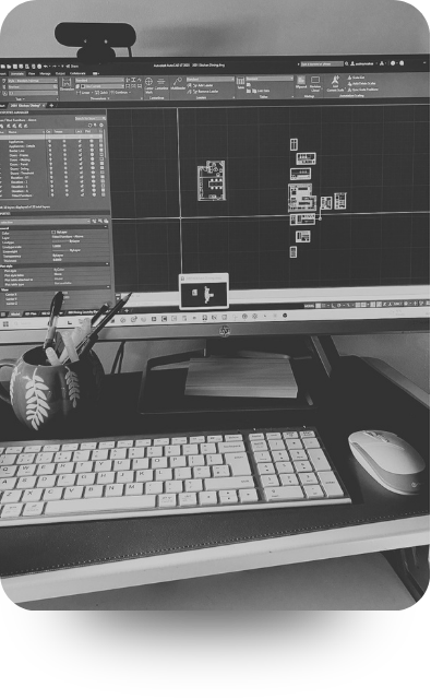Interior designer working confidently at a warm studio desk with AutoCAD open