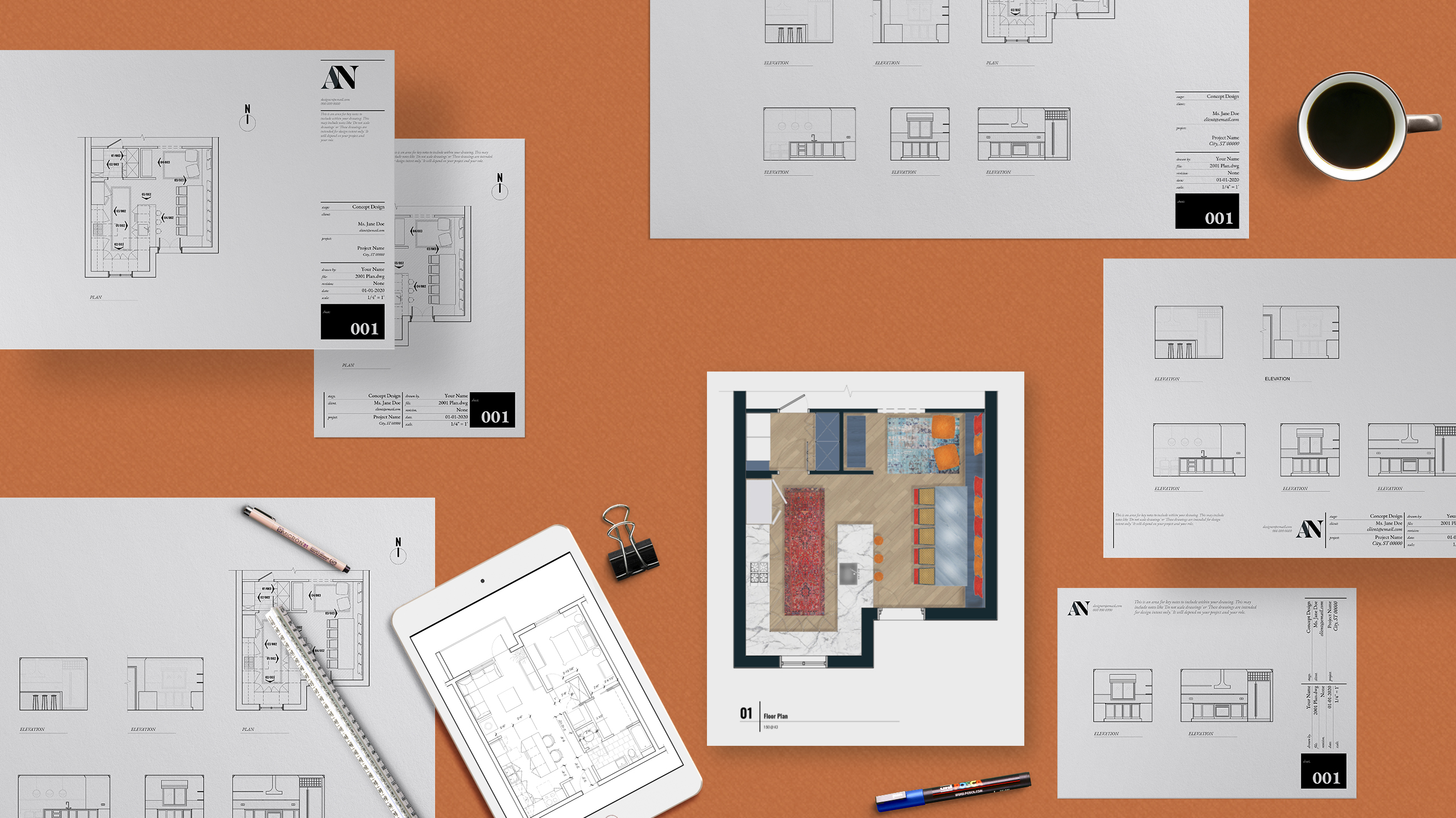 Concept design drawings and floor plans laid out on a desk